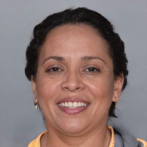 Joyful black adult female with short  brown hair and brown eyes
