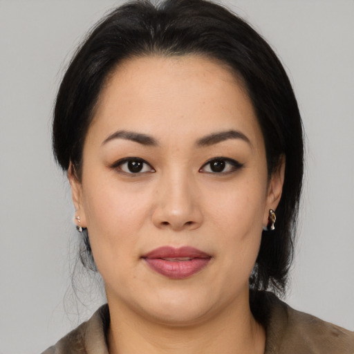 Joyful latino young-adult female with medium  black hair and brown eyes