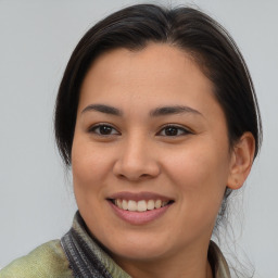 Joyful asian young-adult female with medium  brown hair and brown eyes