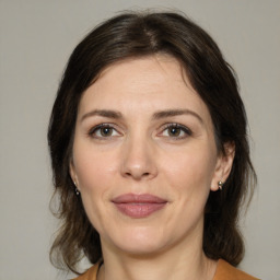 Joyful white adult female with medium  brown hair and brown eyes