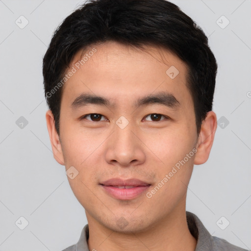 Joyful asian young-adult male with short  brown hair and brown eyes