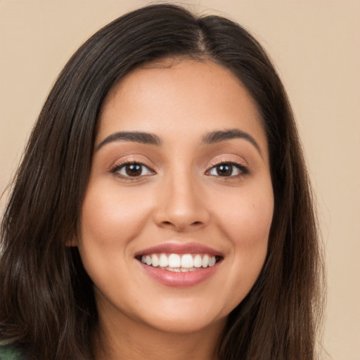 Joyful white young-adult female with long  brown hair and brown eyes