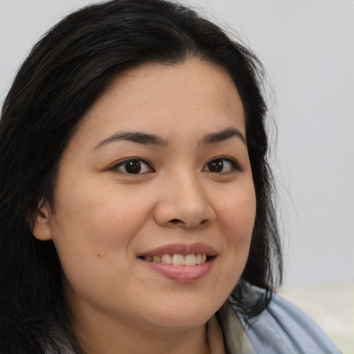 Joyful asian young-adult female with long  brown hair and brown eyes