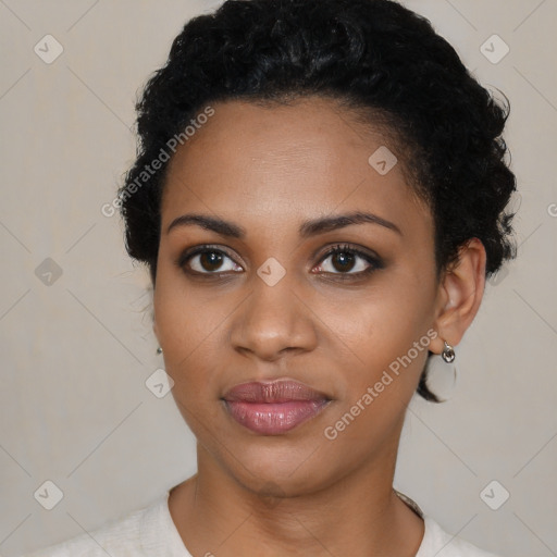 Joyful black young-adult female with short  black hair and brown eyes