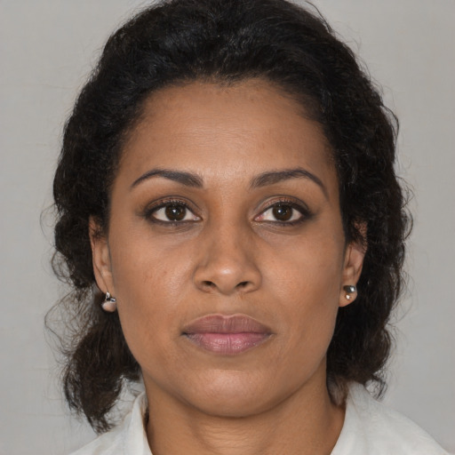 Joyful black young-adult female with medium  brown hair and brown eyes