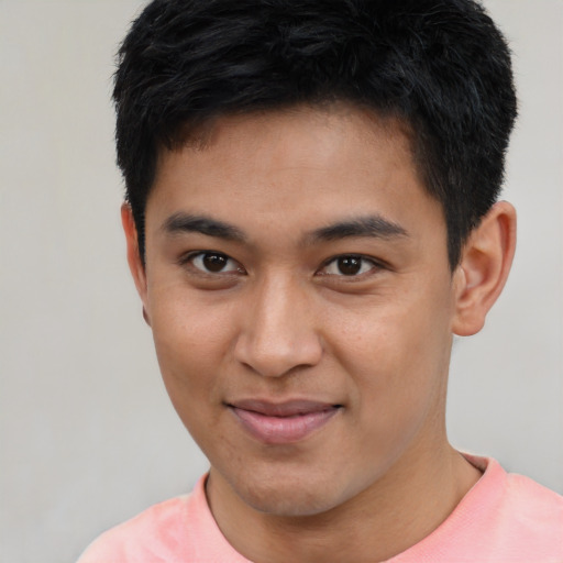 Joyful asian young-adult male with short  black hair and brown eyes