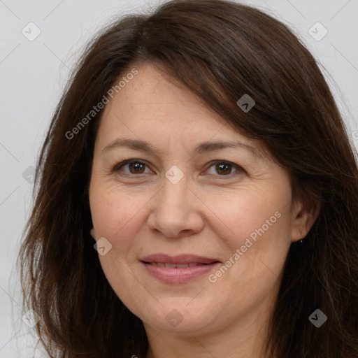 Joyful white adult female with long  brown hair and brown eyes