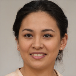 Joyful latino young-adult female with medium  brown hair and brown eyes