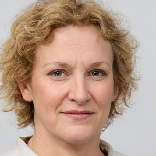 Joyful white adult female with medium  brown hair and blue eyes