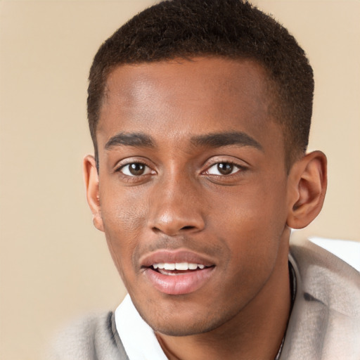 Joyful black young-adult male with short  brown hair and brown eyes