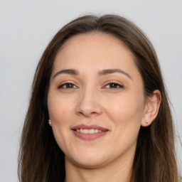 Joyful white adult female with long  brown hair and brown eyes