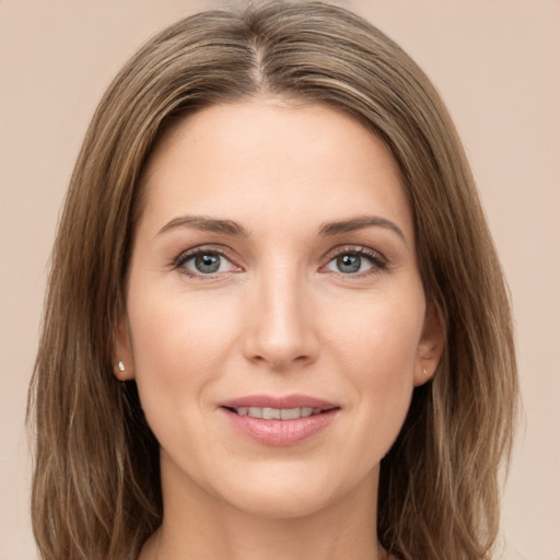 Joyful white young-adult female with long  brown hair and green eyes