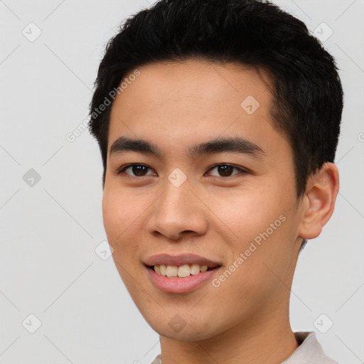 Joyful asian young-adult male with short  black hair and brown eyes