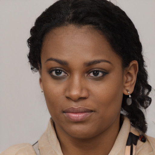 Joyful black young-adult female with long  brown hair and brown eyes