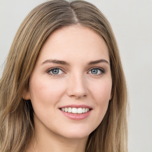 Joyful white young-adult female with long  brown hair and green eyes