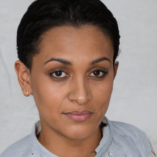 Joyful latino young-adult female with short  brown hair and brown eyes