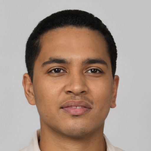 Joyful latino young-adult male with short  brown hair and brown eyes