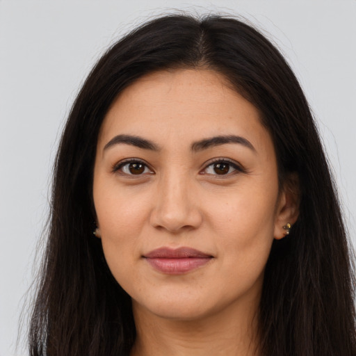 Joyful latino young-adult female with long  brown hair and brown eyes