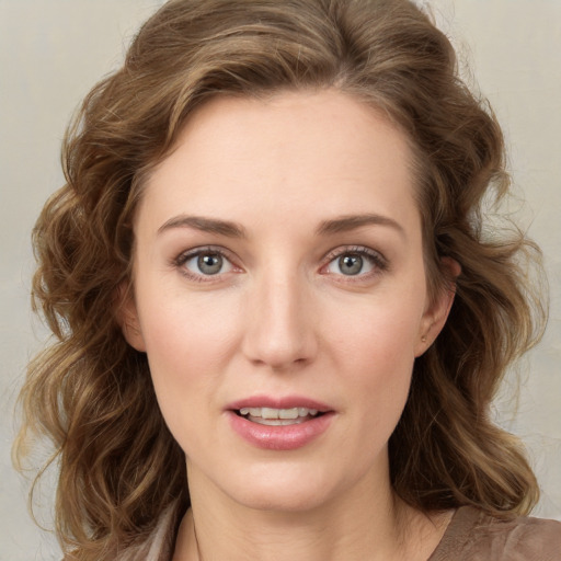 Joyful white young-adult female with medium  brown hair and green eyes