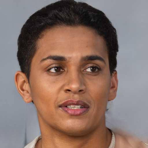 Joyful latino adult male with short  brown hair and brown eyes