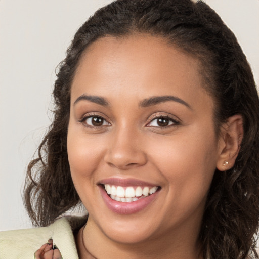 Joyful white young-adult female with long  brown hair and brown eyes