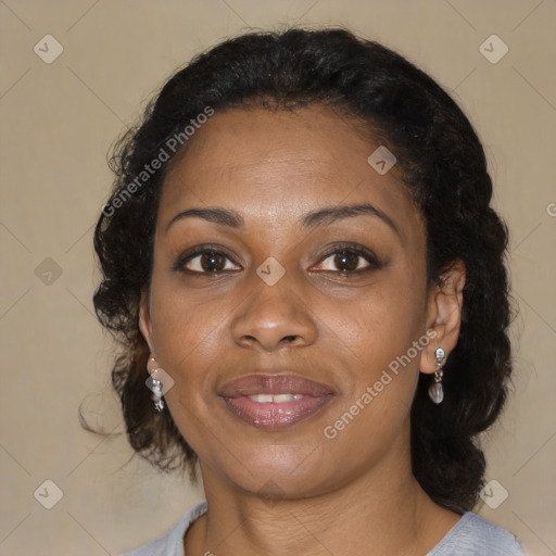 Joyful black adult female with medium  brown hair and brown eyes