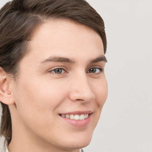 Joyful white young-adult male with medium  brown hair and brown eyes