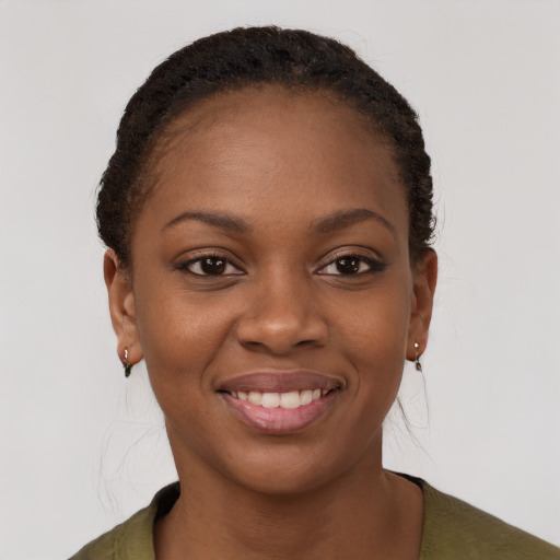 Joyful black young-adult female with long  brown hair and brown eyes