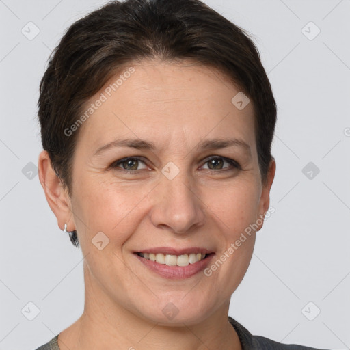 Joyful white adult female with short  brown hair and grey eyes