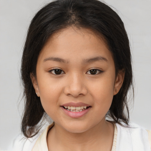 Joyful white child female with medium  brown hair and brown eyes