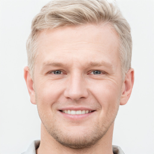 Joyful white adult male with short  brown hair and grey eyes