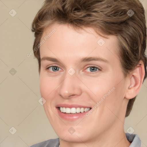 Joyful white young-adult female with short  brown hair and grey eyes