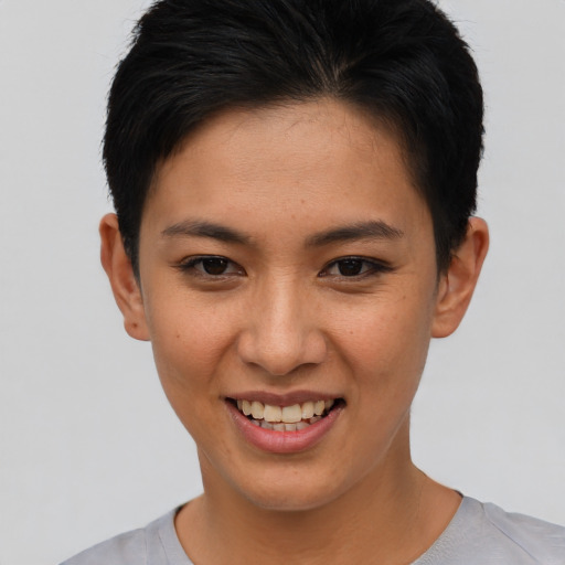 Joyful asian young-adult female with short  brown hair and brown eyes