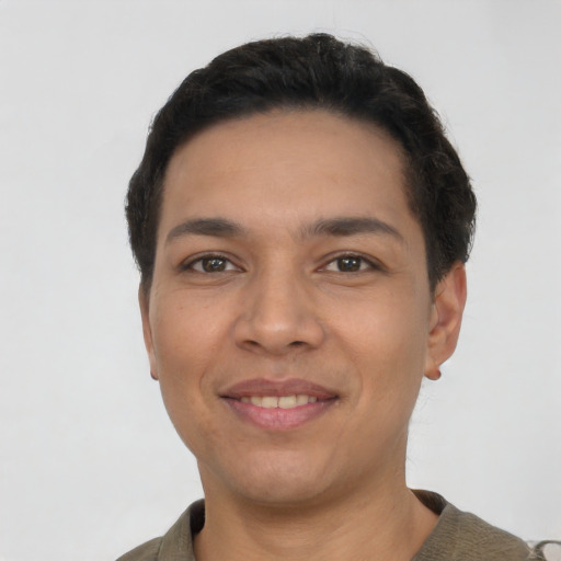 Joyful latino young-adult male with short  black hair and brown eyes