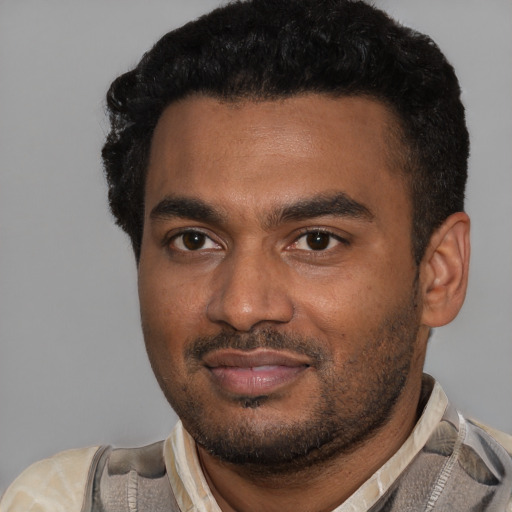 Joyful black young-adult male with short  black hair and brown eyes