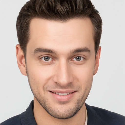 Joyful white young-adult male with short  brown hair and brown eyes