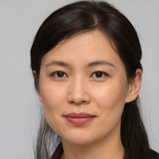 Joyful white young-adult female with medium  brown hair and brown eyes