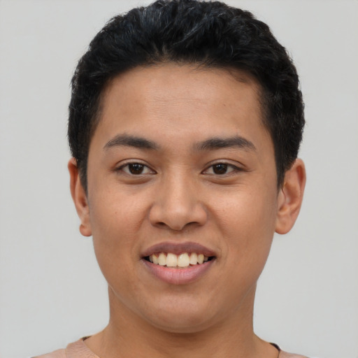 Joyful latino young-adult male with short  black hair and brown eyes