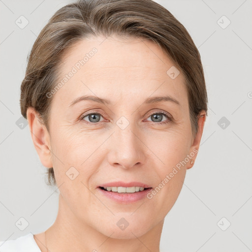 Joyful white adult female with short  brown hair and grey eyes