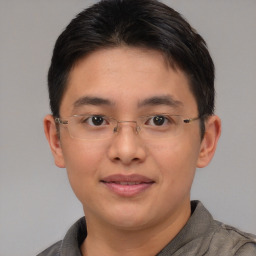 Joyful asian young-adult male with short  brown hair and brown eyes