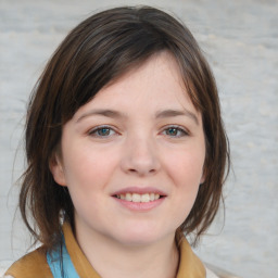 Joyful white child female with medium  brown hair and blue eyes