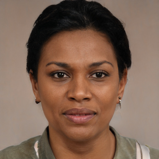 Joyful black young-adult female with short  black hair and brown eyes