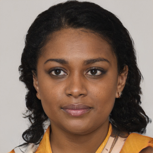 Joyful black young-adult female with medium  brown hair and brown eyes