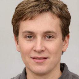 Joyful white adult male with short  brown hair and grey eyes