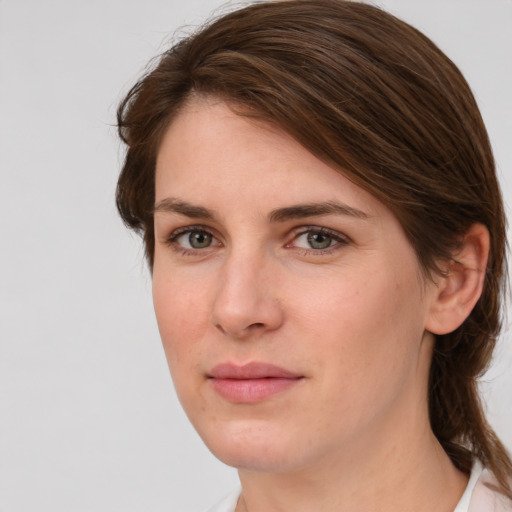 Joyful white young-adult female with medium  brown hair and green eyes