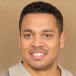 Joyful latino young-adult male with short  brown hair and brown eyes