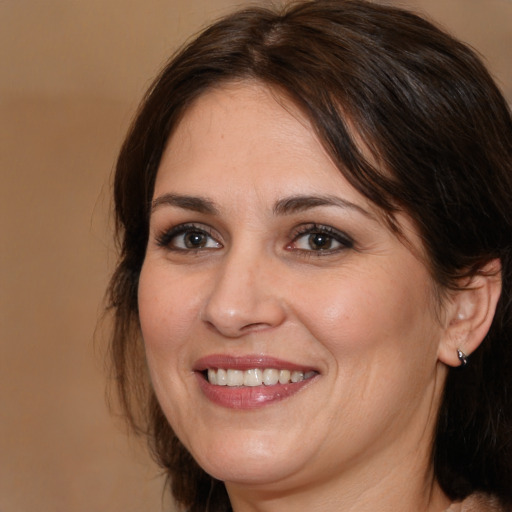 Joyful white young-adult female with medium  brown hair and brown eyes