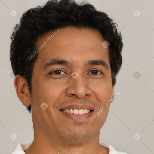 Joyful latino young-adult male with short  brown hair and brown eyes