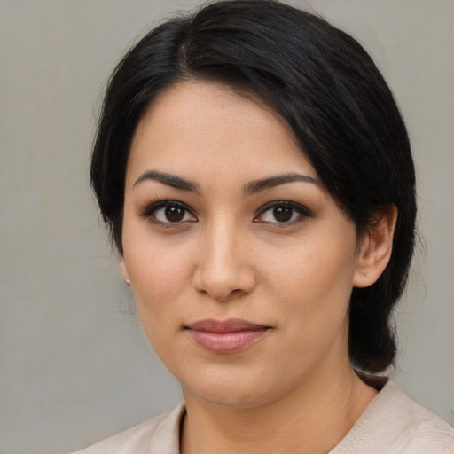 Joyful latino young-adult female with medium  black hair and brown eyes