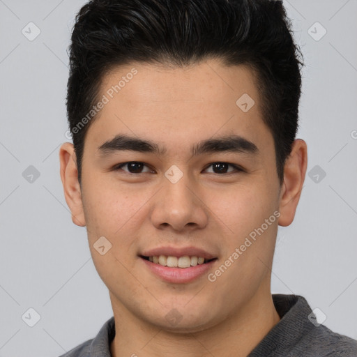 Joyful asian young-adult male with short  brown hair and brown eyes